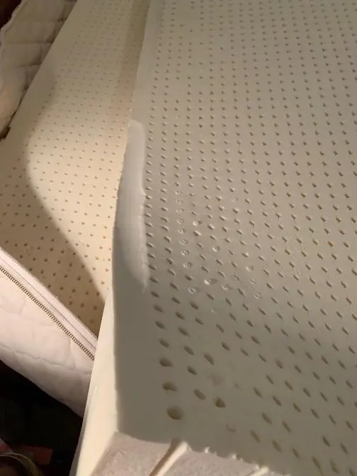 Side variance in natural latex from vacuum between foam and mold during manufacturing
