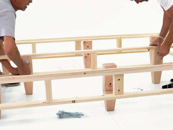 Heavy-duty foundation assembly step 14: Attach the two center-rail legs first.