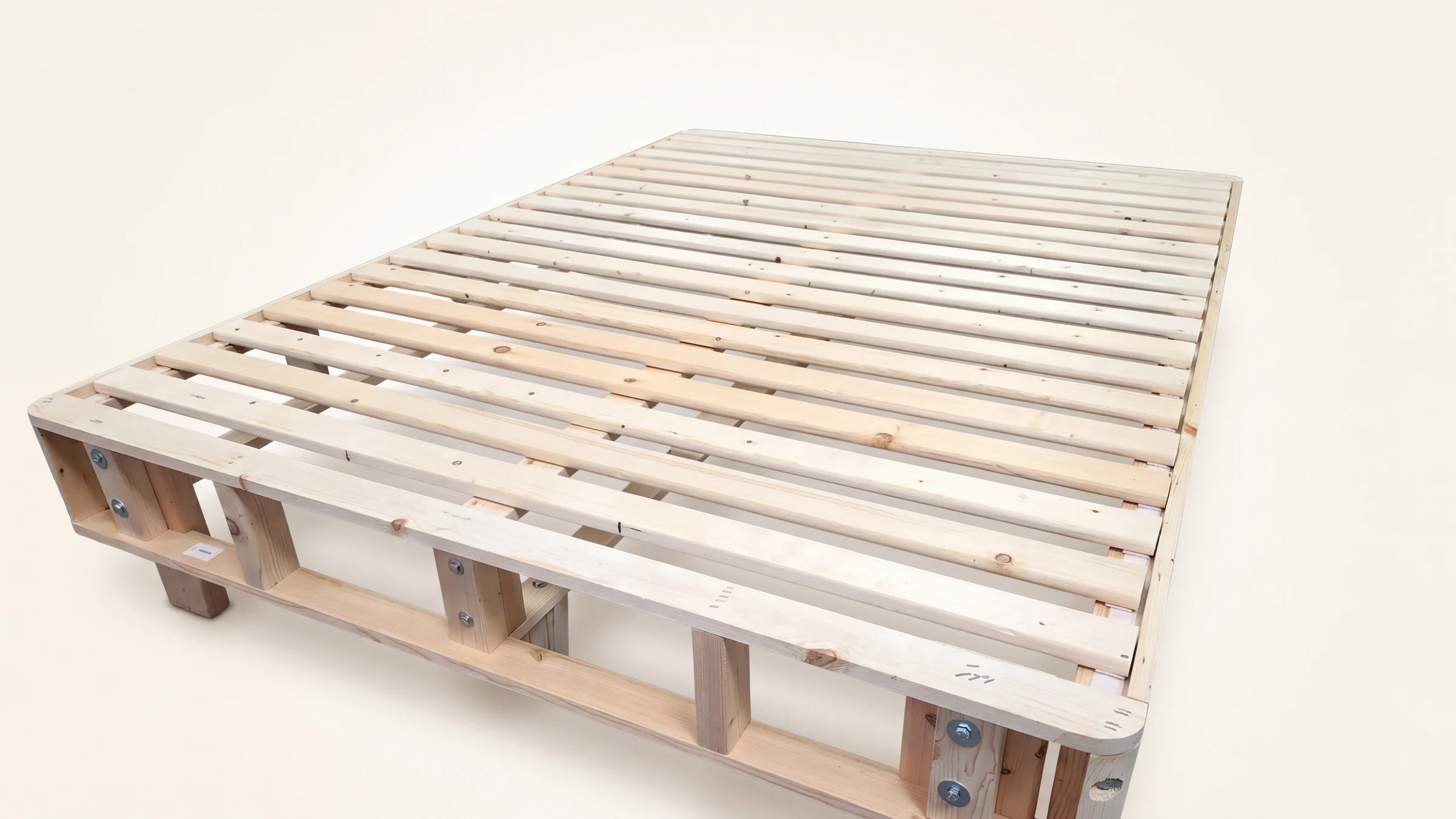 Heavy-duty latex mattress foundation: the solid spruce frame with 18 slats and bolted rails, before the cover goes on