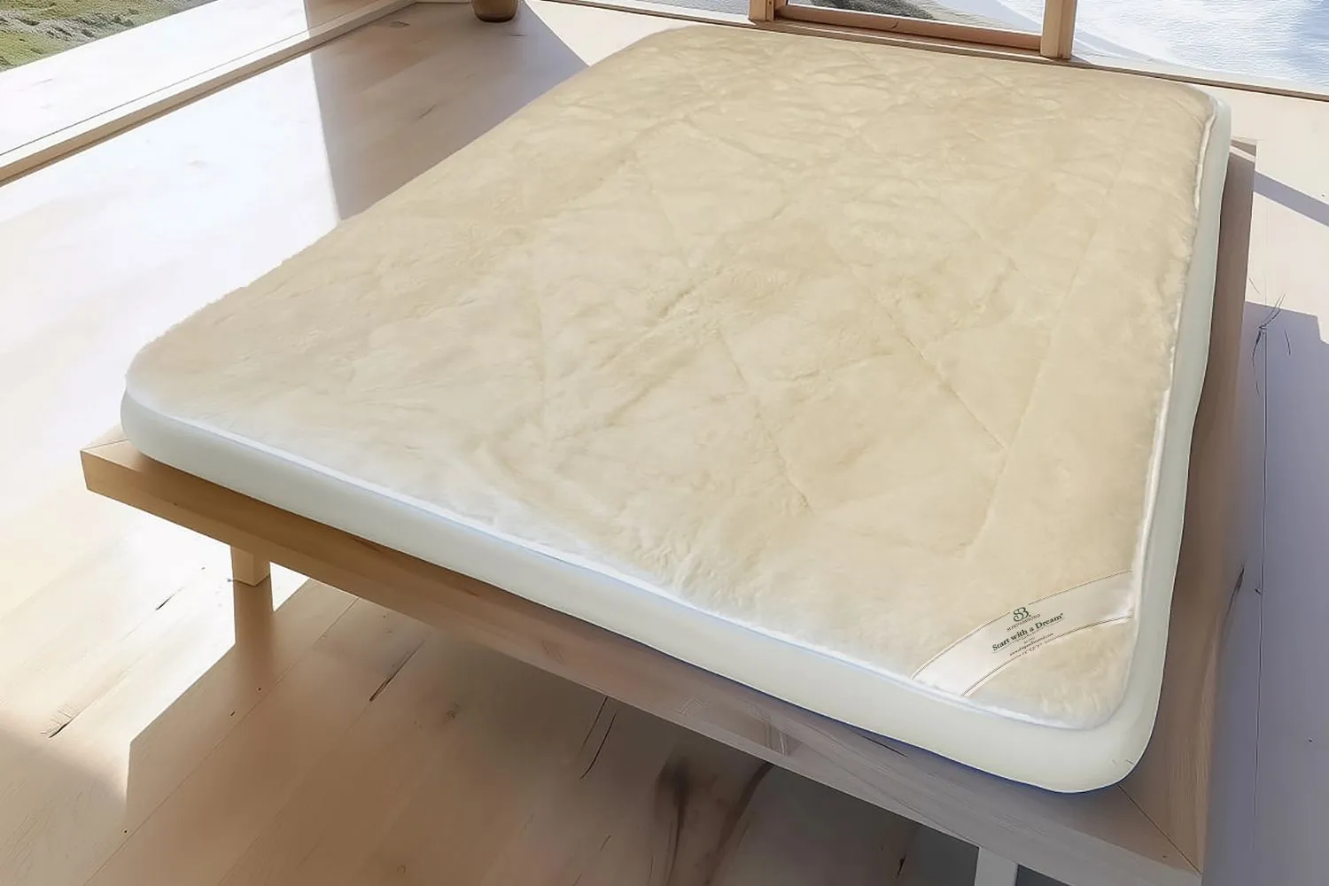 Natural wool mattress pad on bed
