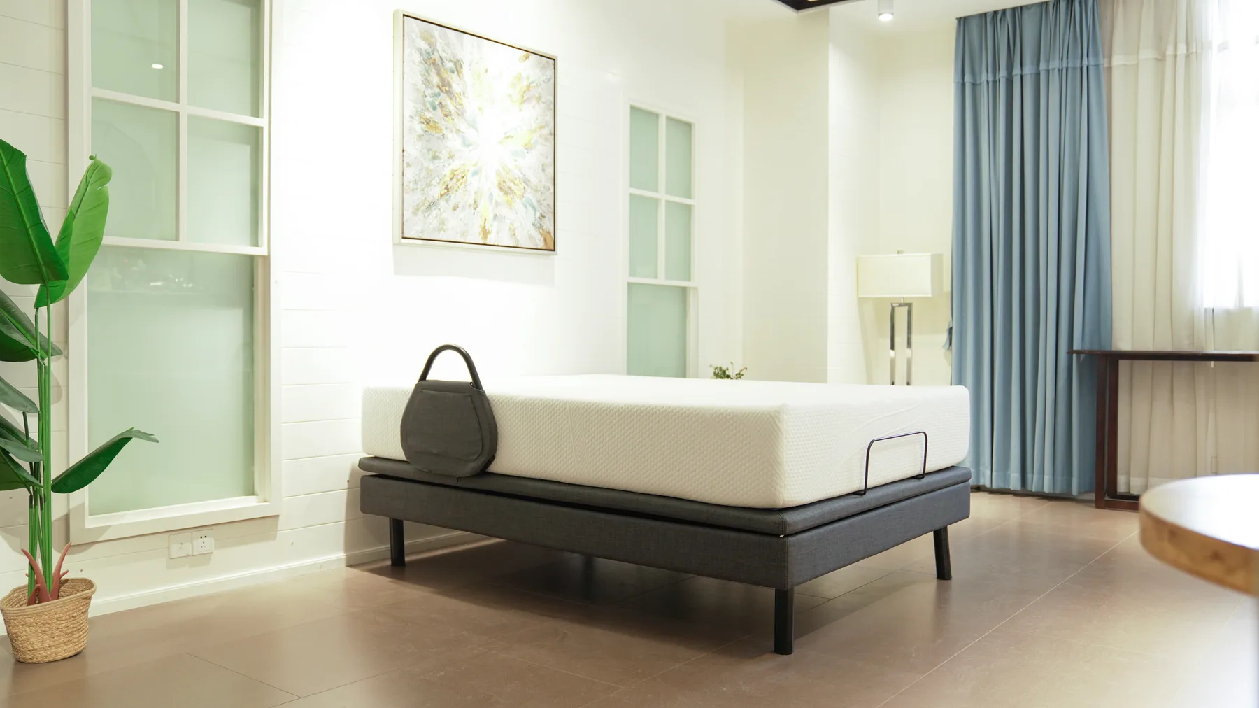 Ergomotion Ascend hi-low adjustable bed with a natural latex mattress in a bright bedroom