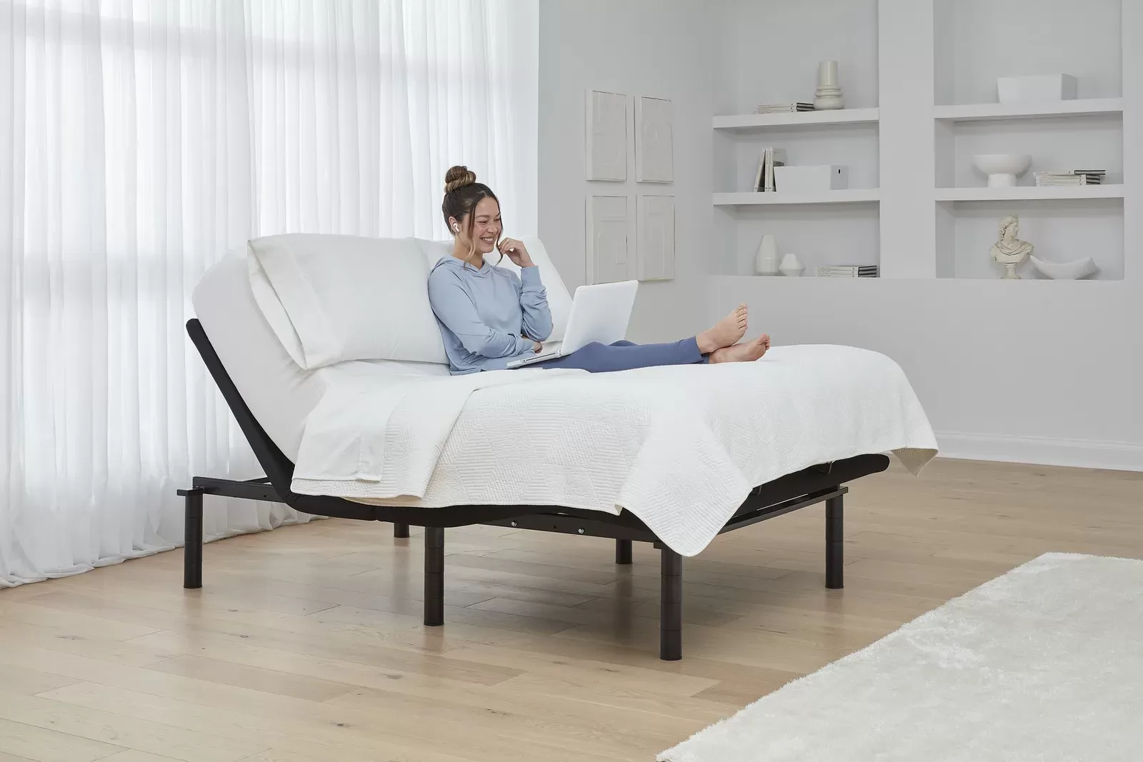 Woman relaxing with head elevated on an Ergomotion Rio adjustable bed
