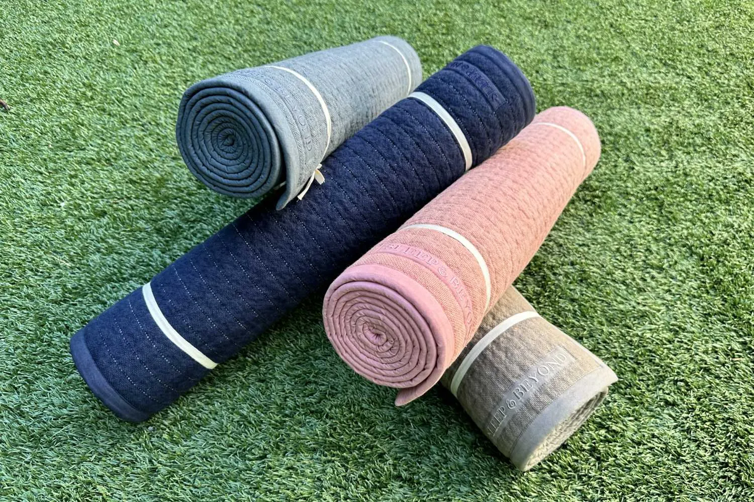 Rolled natural non-slip yoga mats showing multiple color options